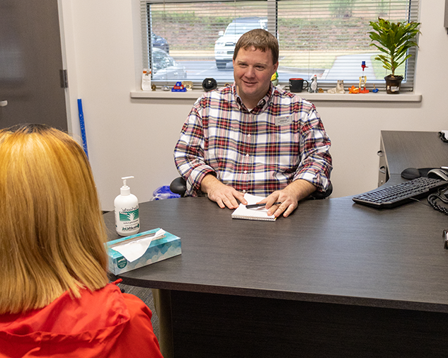 student conversing with health services advocacy staff